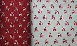 Co-ordinating red and cream patterned cotton fabrics (two pieces)