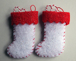 A pair of white and red felt Christmas stockings