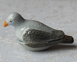 Two-part lidded porcelain casserole dish shaped as a pigeon