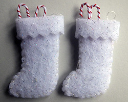 A pair of white felt Christmas stockings